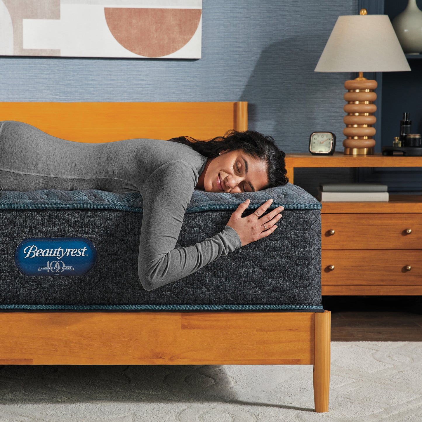 Woman laying on the edge of a Beautyrest mattress asleep