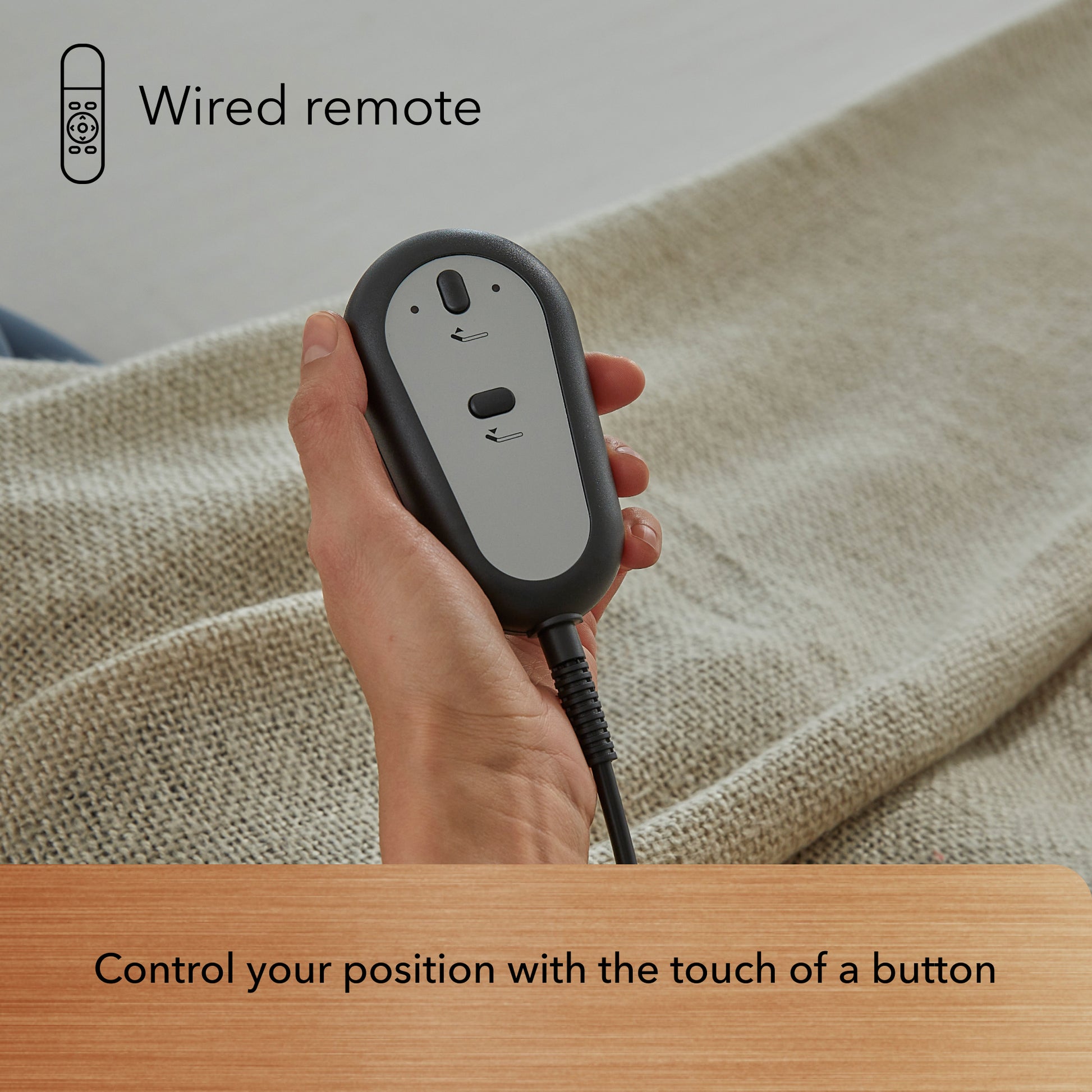 Hand holding Bronze baselogic adjustable base wired remote